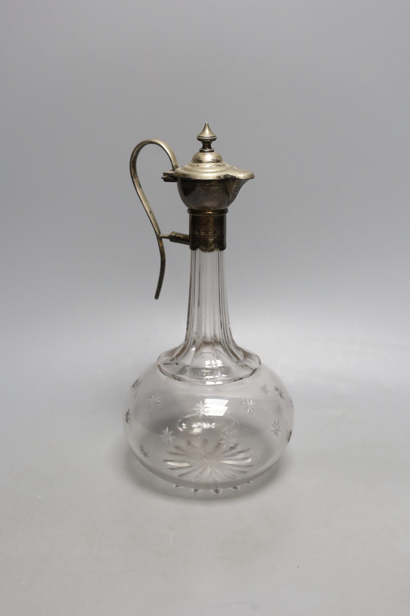 A Victorian plated mounted glass claret jug with patent designed pouring system, 25cm